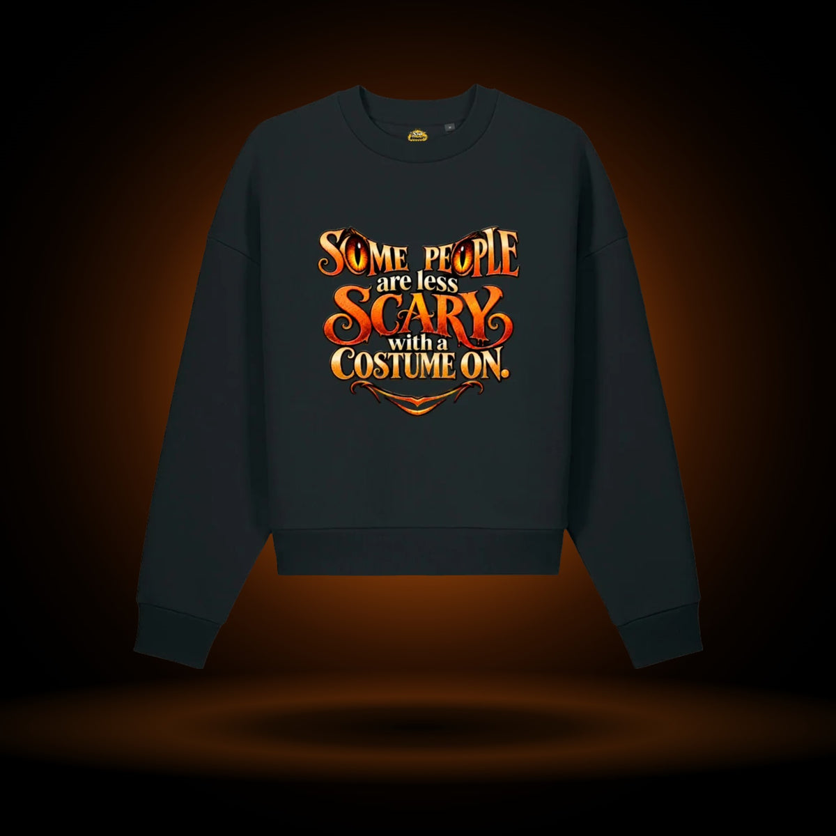 Less Scary in a Costume Halloween sweatshirt, black, with an orange glow